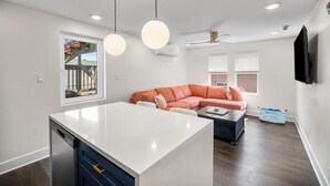 A modern kitchen with a white countertop and a built-in dishwasher.