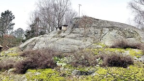 A rocky hill with sparse vegetation and a small structure on top. - 4 Star Holiday Home in Jorlanda (Jorlanda)