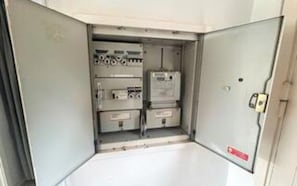 A utility room with electrical panels and equipment.