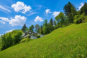 A modern house on a grassy hill with a clear blue sky. - Apartment in Aschau Near Ski Lift Kaltenbach (Aschau Im Zillertal)