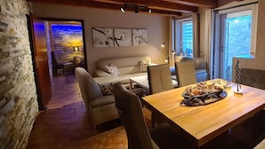 A cozy dining area with a wooden table, chairs, and a decorative centerpiece.