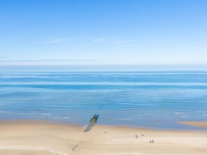 A beach with a clear sky and calm sea. - Exclusive Penthouse With Breathtaking 360deg View (Middelkerke)