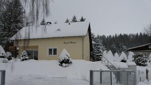 A building labeled "Oertel Haus" with a snow-covered roof and surrounding trees. - Holiday Home Oertel Hausl (Marienberg)