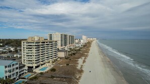 A coastal hotel with multiple floors, a pool, and a beach view. - BREATHTAKING VIEW! 3BR/2BA Condo Unit 8B Centrally Located In North Myrtle Beach (North Myrtle Beach)