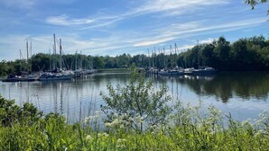 A marina with boats docked, surrounded by greenery and trees. - Attractive Apartment Near Town Center (Wangerland)