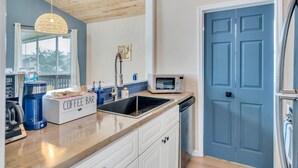 A kitchen with a coffee bar, a microwave, and a dishwasher. - Waterfront, King Suite, Fully Stocked, Minutes from New Orleans, Pets Welcome (Barataria)