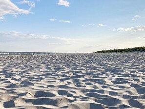 A wide sandy beach with gentle waves in the background and a clear sky. - 7 Person Holiday Home in Loderup (Loderup)
