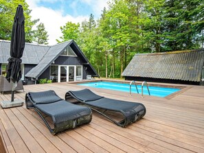 A wooden deck with two lounge chairs and a pool. - 6 Person Holiday Home in Hemmet-by Traum (Hemmet)
