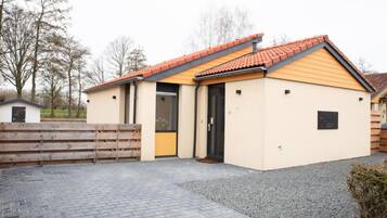 A small, single-story building with a tiled roof and a door.