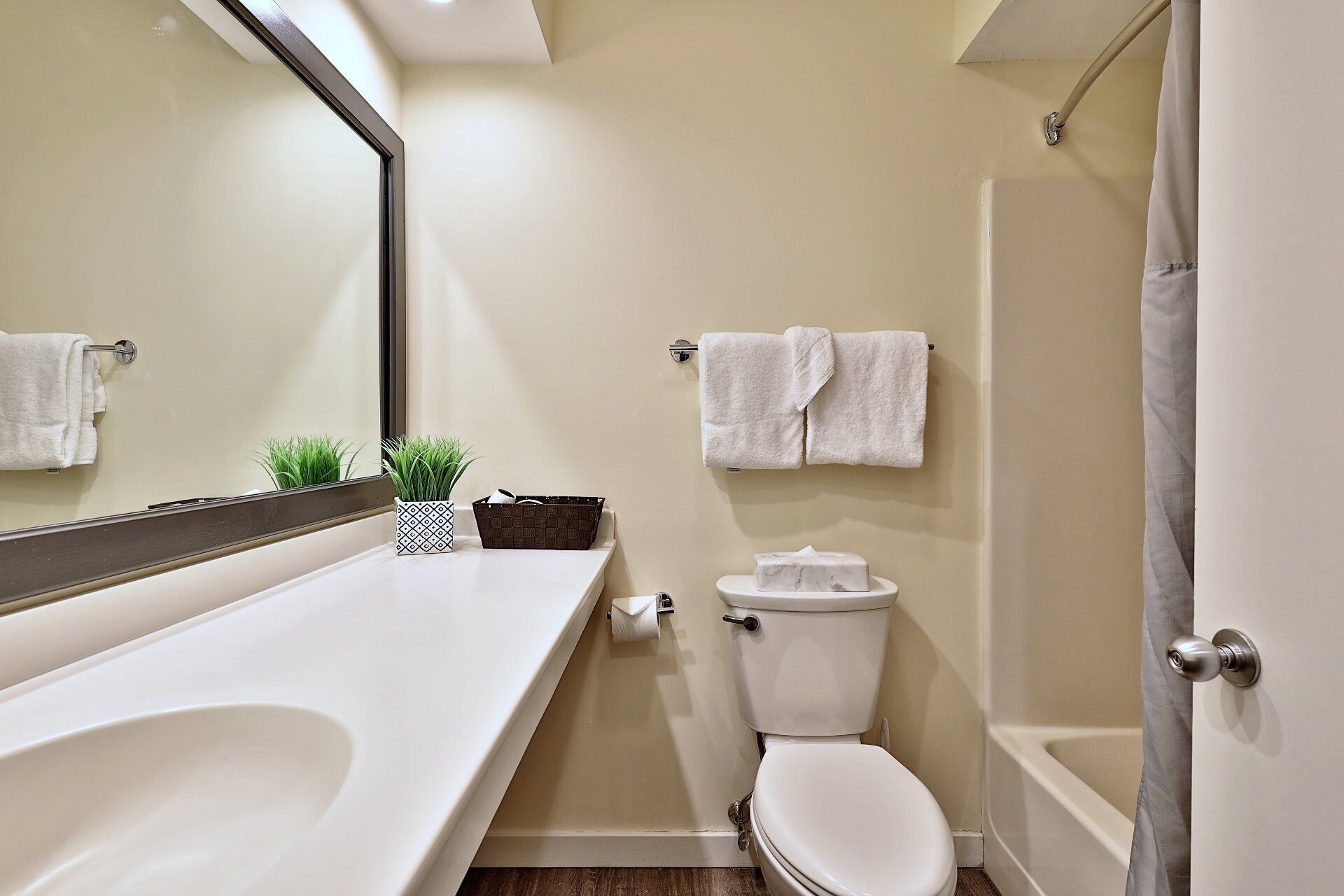 A modern bathroom with a bathtub, toilet, and sink.