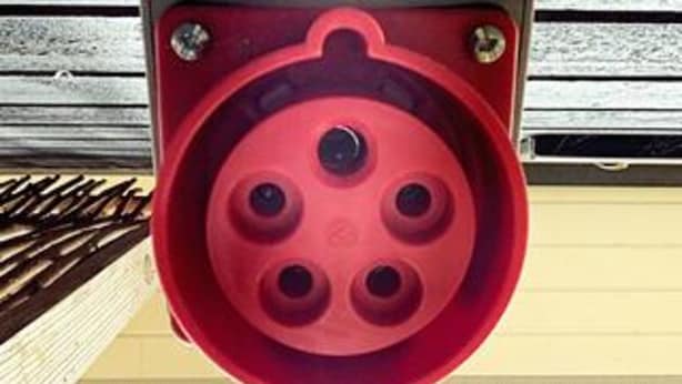 A red circular object with four holes, mounted on a structure with metal bars. - 5 Star Holiday Home in Hundested (Hundested)