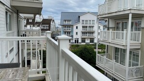 A residential building with multiple balconies and a wooden deck. - Apartment in Nieuwpoort Near the Beach (Nieuwpoort)
