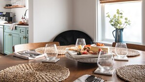A dining table set with plates, glasses, and a variety of food items. - Brick Haven House: King Suite, Near SUU, EV Charger, Parking, Nat’l Parks (Cedar City)