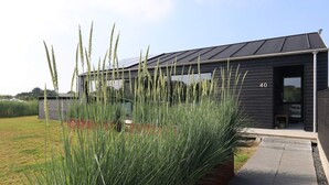 A modern building with a dark exterior, a visible number '40', and a pathway leading to the entrance. - 5 Star Holiday Home in Hirtshals (Hirtshals)