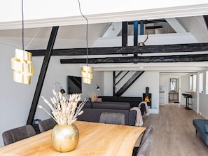 A modern interior with a dining area, a sofa, and a fireplace. - 10 Person Holiday Home in Auning (Auning)