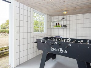 A foosball table labeled 'StanLord' in a room with white tiled walls and a window. - 10 Person Holiday Home in Auning (Auning)