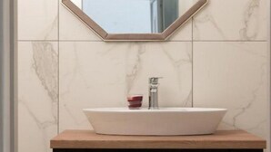 A bathroom with a white sink, a wooden vanity, a mirror, and a towel rack. - Apartments Bella Vista - One Bedroom Apartment With Terrace (Kastav)