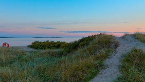 A beach path leading to the sea with a lifebuoy visible. - 8 Person Holiday Home in Skummeslovsstrand (Skummesloevsstrand)