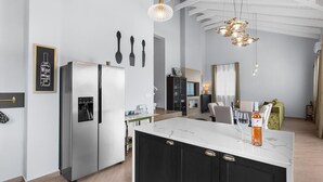 A modern kitchen with a central island, stainless steel appliances, and pendant lighting. - Modern Villa With Swimming Pool and Fenced Garden (Zminj)