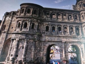 An ancient stone structure with multiple arches and columns, likely a historical monument or gate. - Rednak Modern Retreat (Polch)