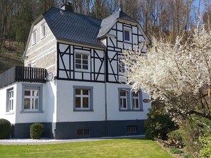A traditional half-timbered house with a symmetrical facade, multiple windows, and a well-maintained lawn. - Holiday Home Haus am Anger (Winterberg)