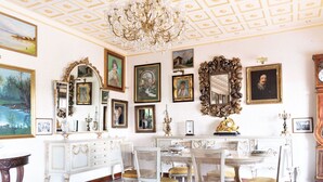A room with a marble floor, a chandelier, ornate furniture, and various framed artworks on the walls. - Belvilla by OYO Villa Teodora (Anguillara Sabazia)