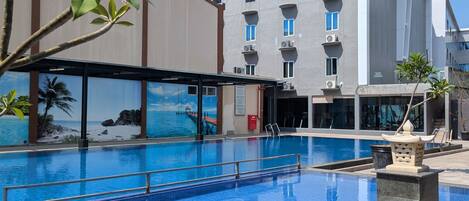 Alberca al aire libre y camastros