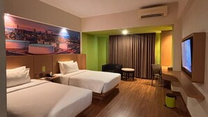 A hotel room with two beds, a desk, a chair, a television, and a large cityscape painting on the wall. - MaxOne Dumai (Dumai)