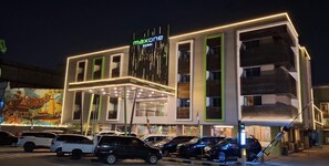A modern building with a sign reading 'maxone DUMAI' and multiple parking spaces in front. - MaxOne Dumai (Dumai)