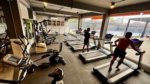 A gym with treadmills, stationary bikes, and weight machines. - MaxOne Dumai (Dumai)