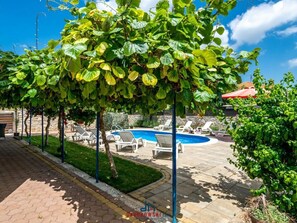 A pool area with lounge chairs and a swimming pool. - Andrea Comfortable Holiday Residence (Marcana)