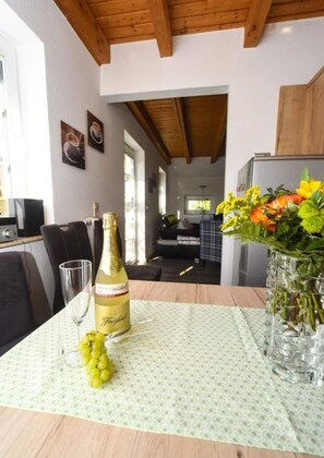Enjoy a romantic dinner for two in this cozy dining area, complete with a table set and a view into the adjacent room.