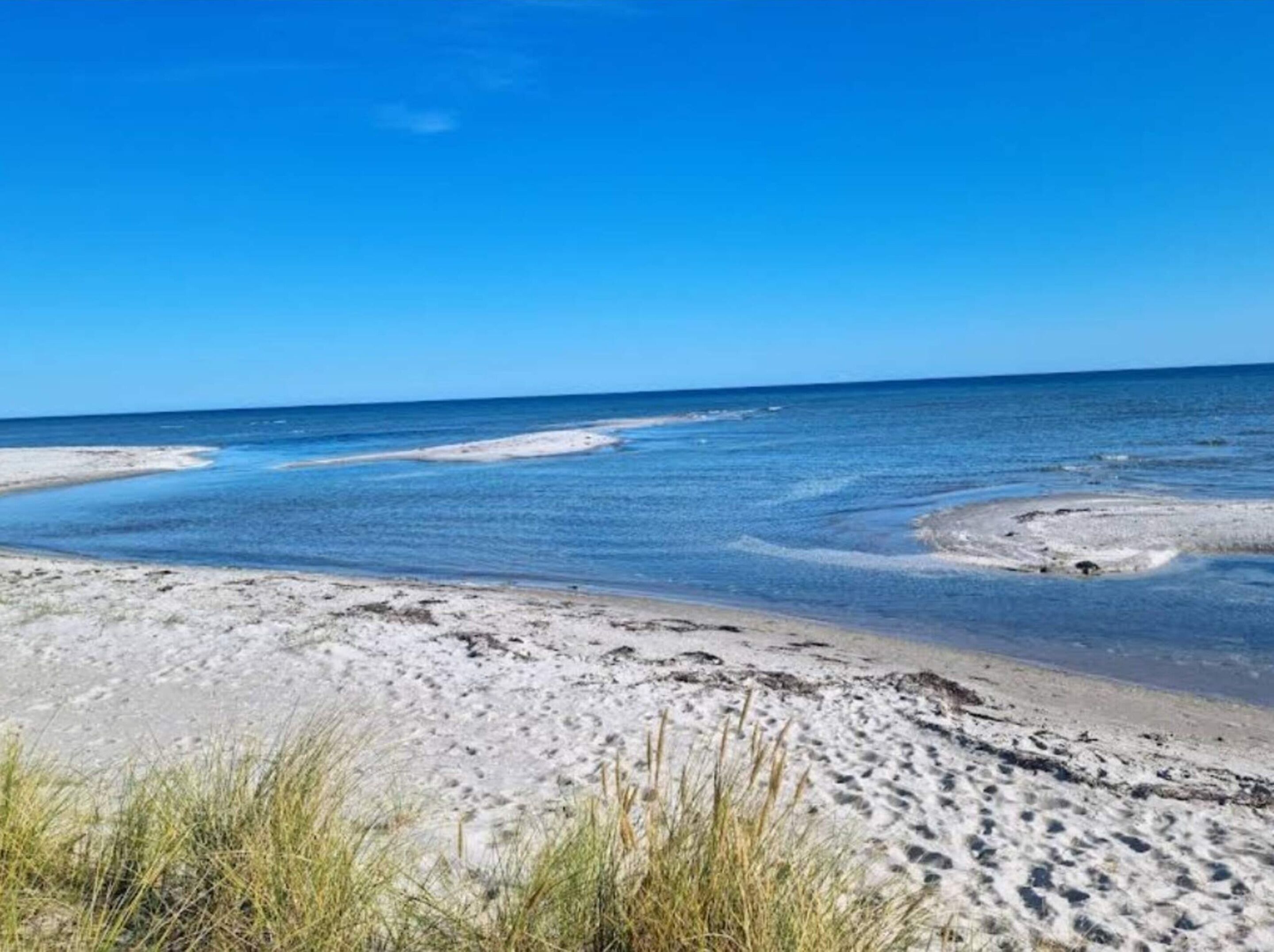 A beach with clear skies and calm waters.