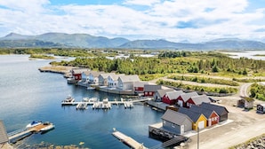 A coastal village with a dock, boats, and houses. - 6 Person Holiday Home in Bud (Averoy)