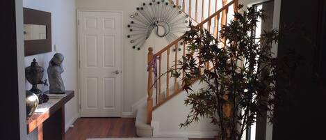 A staircase with wooden railings and a decorative wall piece.