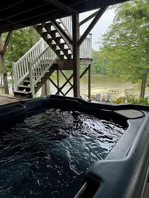 A hot tub with a wooden deck and stairs leading to a covered area. - Hyco Hills Hideaway- private location, close to VIR, fast wi-fi, HOT TUB (Semora)