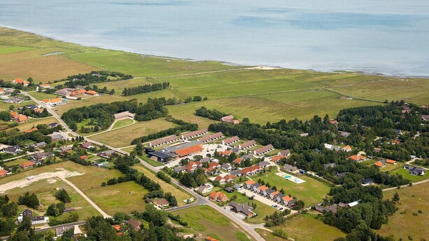 An aerial view of a coastal town with residential areas, a main road, and a large body of water. - 10 Person Holiday Home on a Holiday Park in Blavand (Blavand)