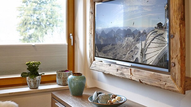 A room with a large window, a rustic wooden frame, and a view of a mountainous landscape. - Apartment in Garmisch-partenkirchen (Garmisch-Partenkirchen)