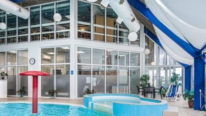 An indoor swimming pool with a red pillar, glass walls, and a blue ceiling. - 4 Person Holiday Park Home in Hejls (Hejls)