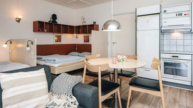 A compact, modern room with a bed, a sofa, a dining table, and a kitchenette. - 4 Person Holiday Park Home in Hejls (Hejls)