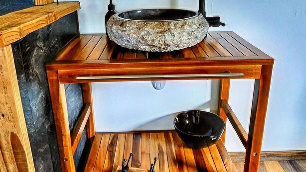 A rustic wooden table with a stone basin sink and a black bowl. - Quaint Holiday Home in Lamswaarde With Garden (Lamswaarde)