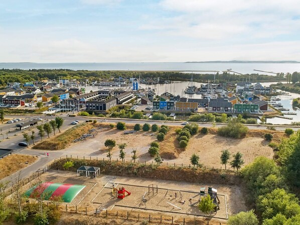 Eine Küstenstadt mit einem Yachthafen, Sandstränden und einem Spielplatz.