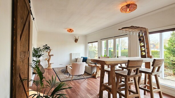 A spacious dining area with wooden furniture and a view of the outdoors.