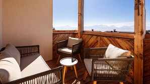 A wooden deck with wicker furniture and a view of mountains. - Holiday Apartment in Gerlitzen With Wellness Area (Treffen)
