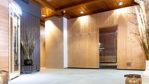 A modern interior with wooden panel walls, a reception area, and a sauna room. - Holiday Apartment in Gerlitzen With Wellness Area (Treffen)