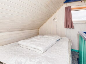 A single bed with a white mattress and a brown curtain. - 9 Person Holiday Home in Thyholm (Thyholm)