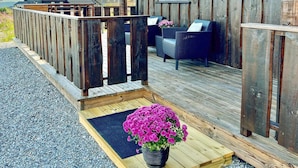 A wooden deck with a bench and a potted plant. - 8 Person Holiday Home in Osen (Åmot)