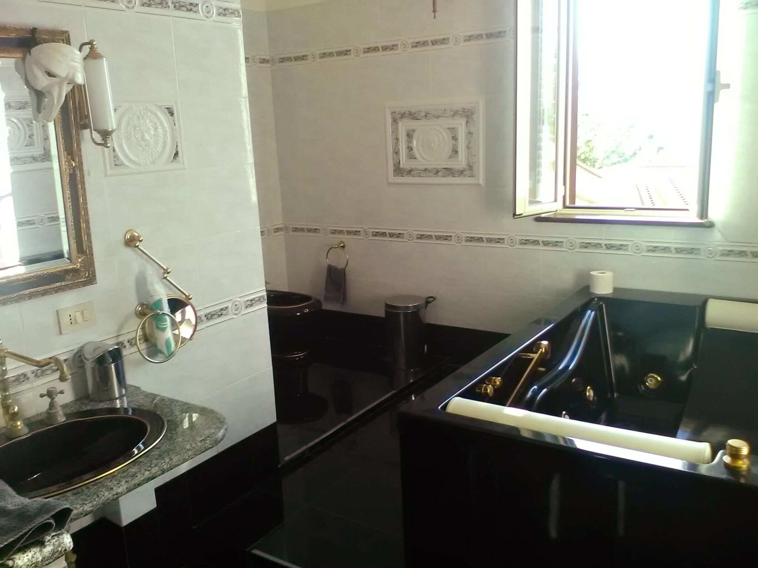 A kitchen with a sink, stove, and window.