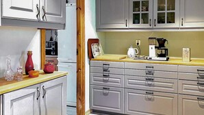 A kitchen with grey cabinets, a wooden countertop, and a coffee maker. - 4 Star Holiday Home in Onsala (Gottskar)