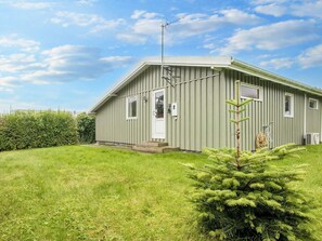 A single-story building with a flat roof, a door, and a window. - 5 Person Holiday Home in Juelsminde (Horsens)